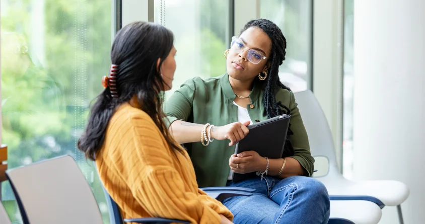 A supervisor and an intern in conversation