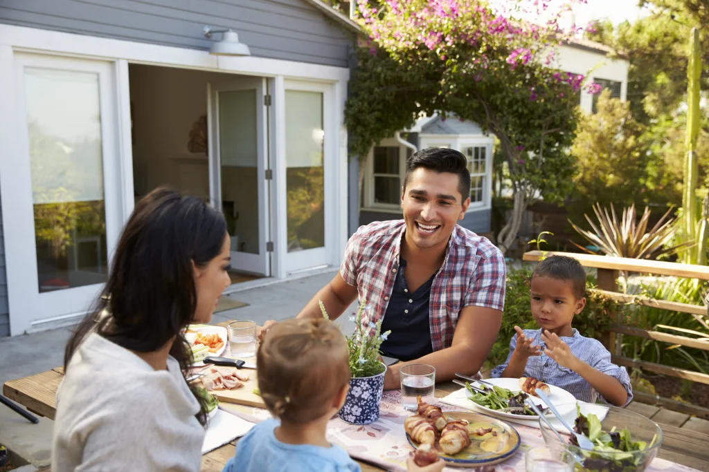 A family eating a meal together outdoors